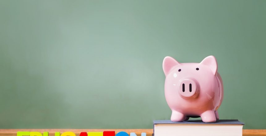 Education theme with textbooks and piggy bank and green chalkboard background